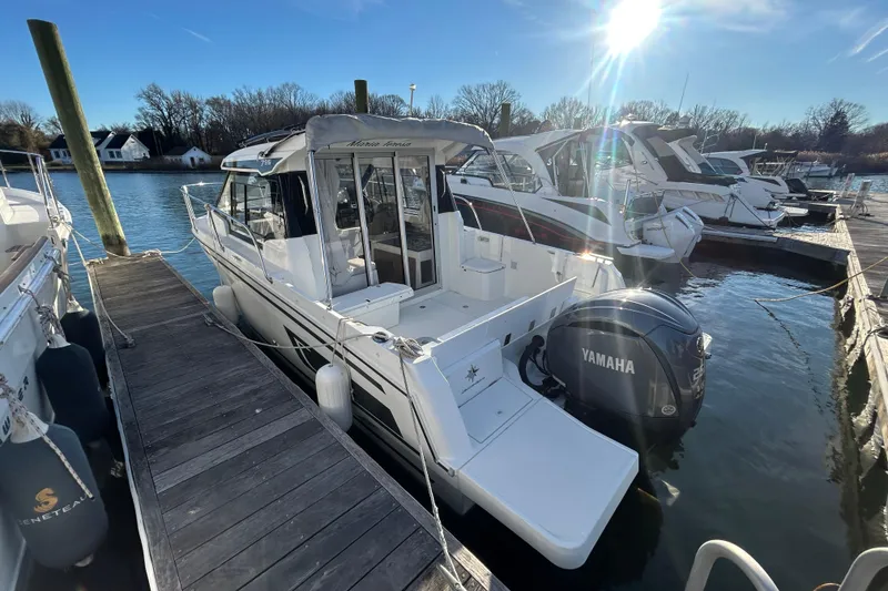 Slide: The Image of 2023 Jeanneau NC 795 Series 2 boat docked with Yamaha outboard motor. - 3