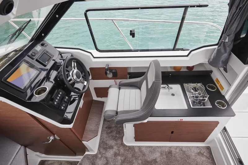 Slide: The Image of 2023 Jeanneau NC 795 Series 2 boat interior with helm, sink, and stove. - 6