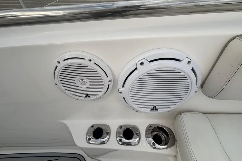 Slide: The Image of Edgewater 320CC 2015 boat speakers and cup holders on white interior panel. - 17