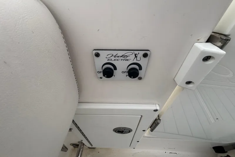 Slide: The Image of Control panel on a 2015 Edgewater 320CC boat, featuring Harken Electric switches. - 21
