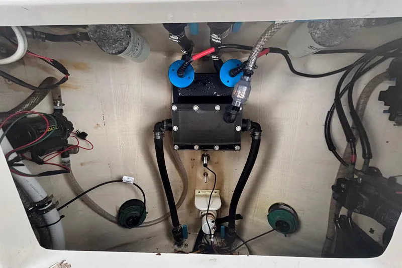 Slide: The Image of Interior view of 2015 Edgewater 320CC boat's engine compartment with wiring and components. - 22