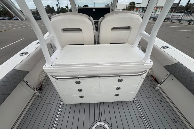 Slide: The Image of 2015 Edgewater 320CC boat interior with seating and storage compartments. - 25