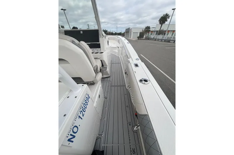 Slide: The Image of 2015 Edgewater 320CC boat interior with seating and deck view. - 29