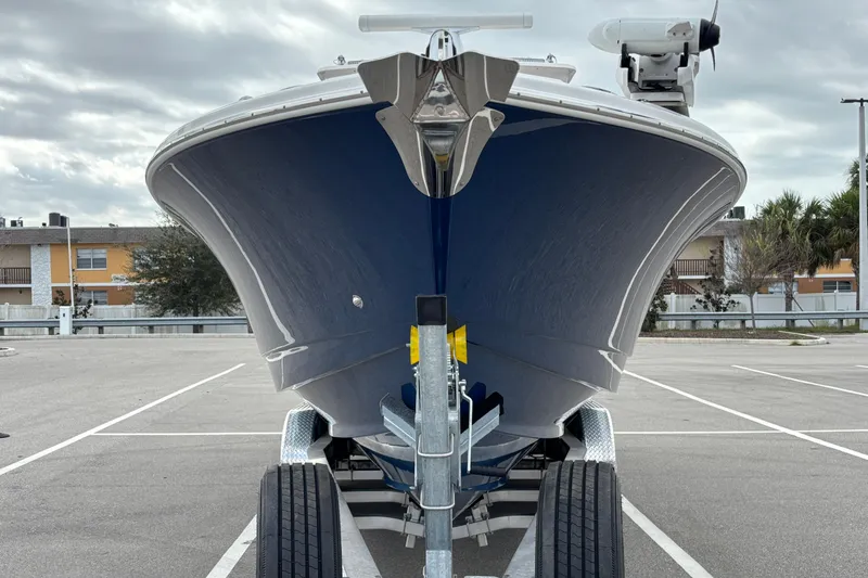 Slide: The Image of Front view of a 2015 Edgewater 320CC boat on a trailer in a parking lot. - 3