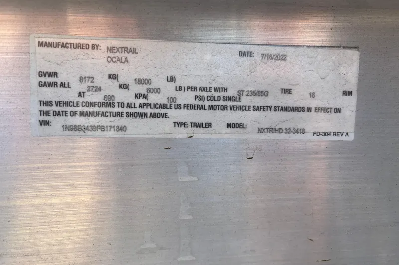 Slide: The Image of Label on a Nextrail trailer, detailing weight specifications and compliance information. - 31