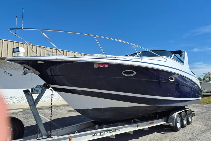 Slide: The Image of 2003 Chris-Craft 328 Express Cruiser on trailer under clear blue sky. - 1