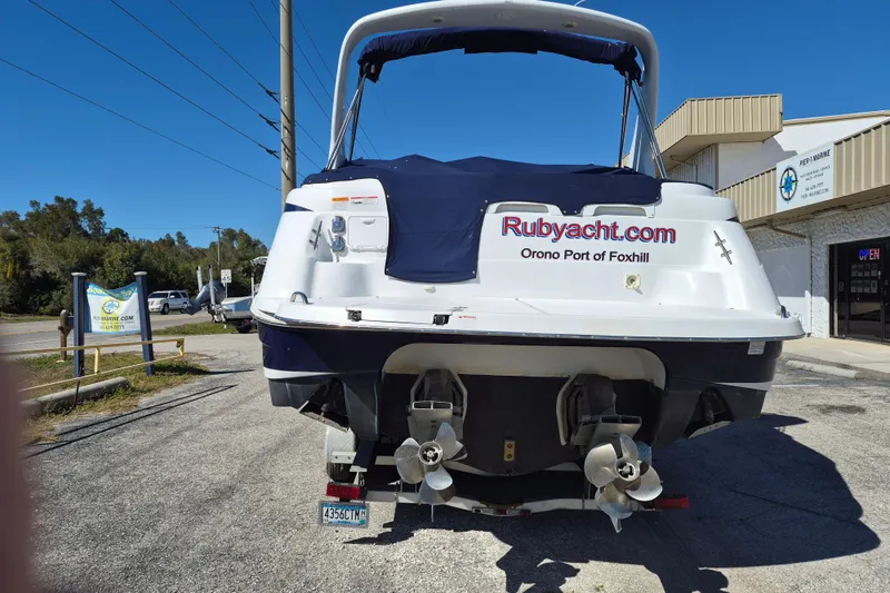 Slide: The Image of 2003 Chris-Craft 328 Express Cruiser docked at marina, rear view with dual propellers. - 5