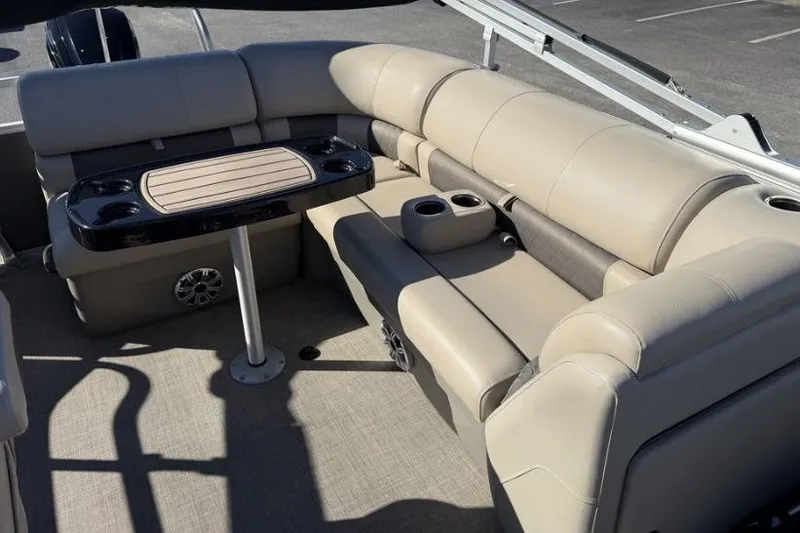 Slide: The Image of 2023 Sun Tracker Party Barge 20 DLX, beige seating, outdoor setting. - 10