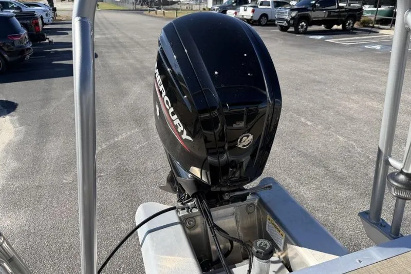 Slide: The Image of 2023 Sun Tracker Party Barge 20 DLX dashboard with steering wheel and gauges. - 12