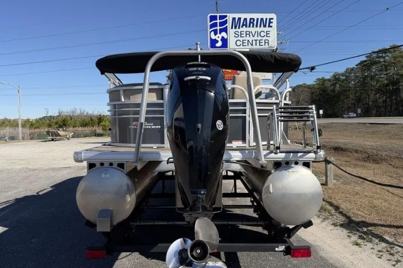 Slide: The Image of 2023 Sun Tracker Party Barge 20 DLX interior with beige seating and table. - 13