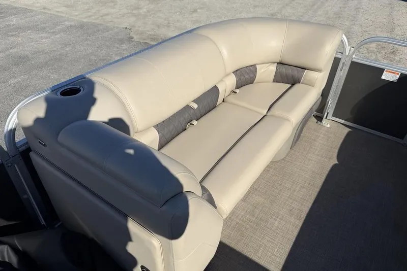 Slide: The Image of 2023 Sun Tracker Party Barge 20 DLX pontoon boat with beige seating and cup holder. - 14