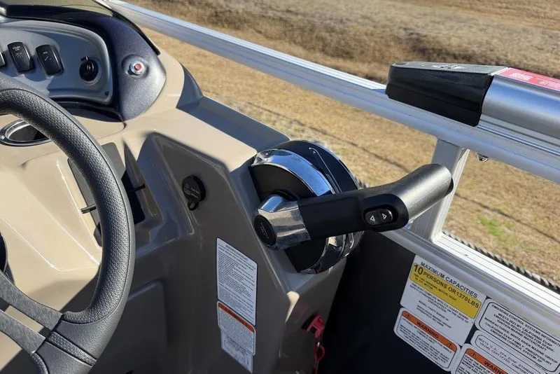 Slide: The Image of 2023 Sun Tracker Party Barge 20 DLX steering console with throttle and control panel. - 15