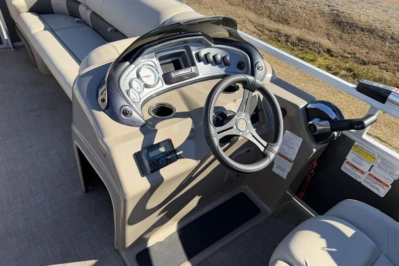 Slide: The Image of 2023 Sun Tracker Party Barge 20 DLX helm with steering wheel and controls. - 21