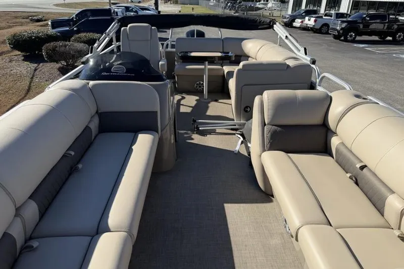 Slide: The Image of 2023 Sun Tracker Party Barge 20 DLX pontoon boat on trailer, outdoor dealership setting. - 4