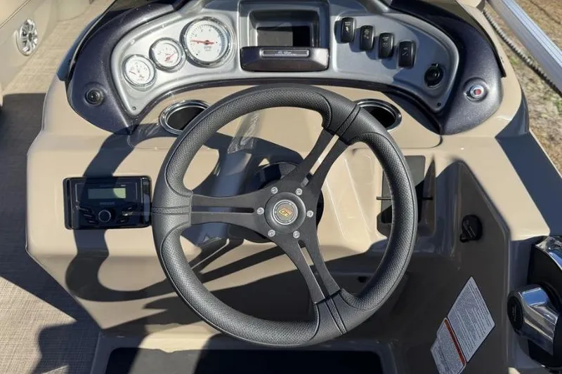 Slide: The Image of 2023 Sun Tracker Party Barge 20 DLX pontoon boat on trailer, parked outdoors. - 7