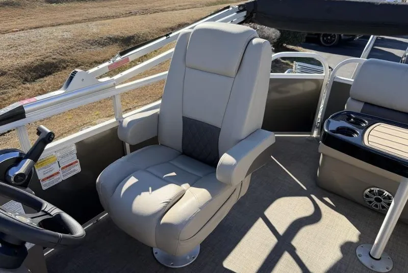 Slide: The Image of 2023 Sun Tracker Party Barge 20 DLX interior with captain's chair and console. - 9