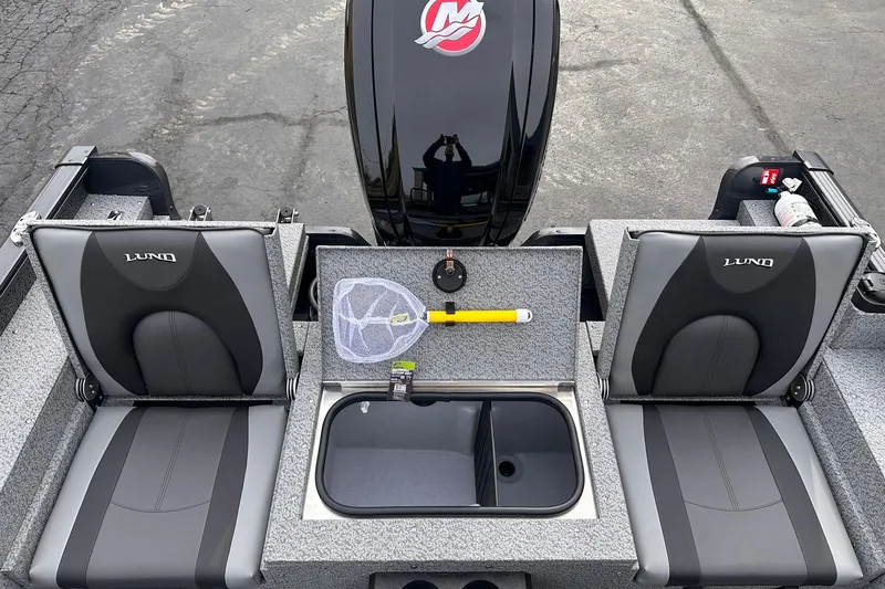 Slide: The Image of 2026 Lund 1775 Adventure Sport boat interior with seats, storage, and fishing gear. - 10