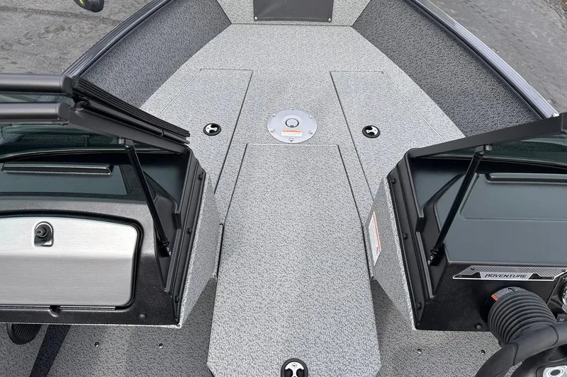 Slide: The Image of 2026 Lund 1775 Adventure Sport boat interior with open compartments and textured flooring. - 12