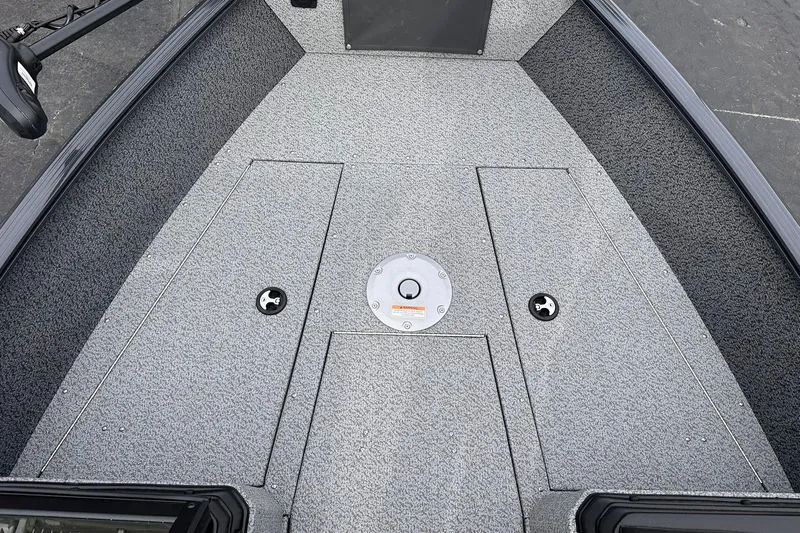 Slide: The Image of 2026 Lund 1775 Adventure Sport boat deck with storage compartments and textured flooring. - 13