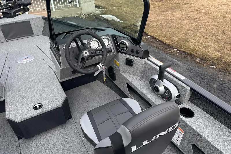 Slide: The Image of 2026 Lund 1775 Adventure Sport boat interior with steering wheel and controls. - 15
