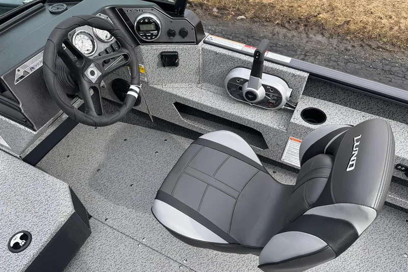Slide: The Image of 2026 Lund 1775 Adventure Sport boat interior with steering wheel and control panel. - 16