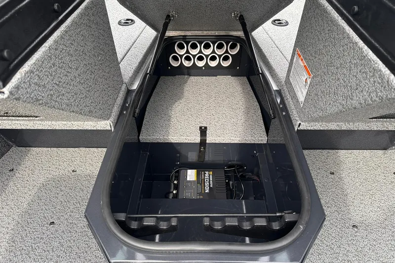 Slide: The Image of 2026 Lund 1775 Adventure Sport boat storage compartment with battery and rod holders. - 19