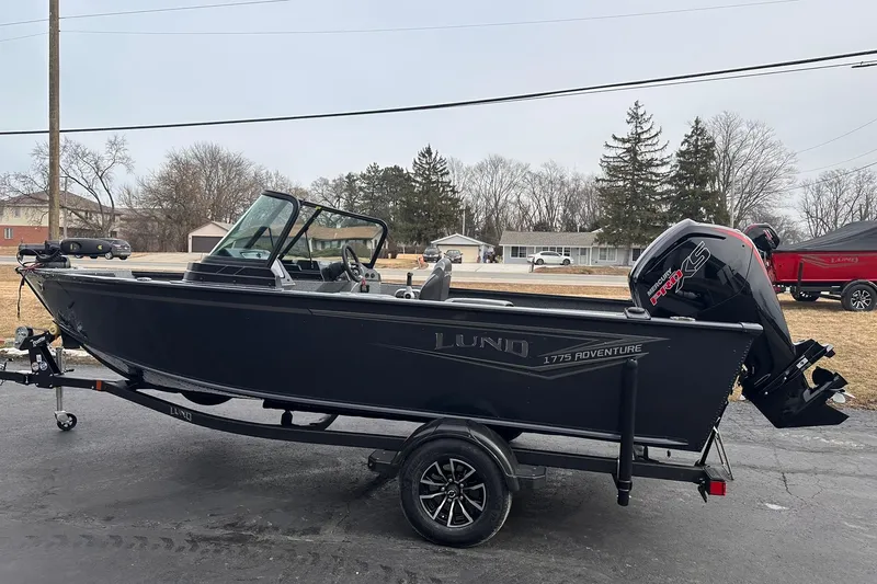 Slide: The Image of 2026 Lund 1775 Adventure Sport boat on trailer, parked outdoors. - 3