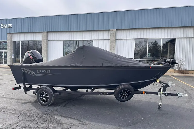Slide: The Image of 2026 Lund 1775 Adventure Sport boat with cover on trailer, parked outside sales building. - 4