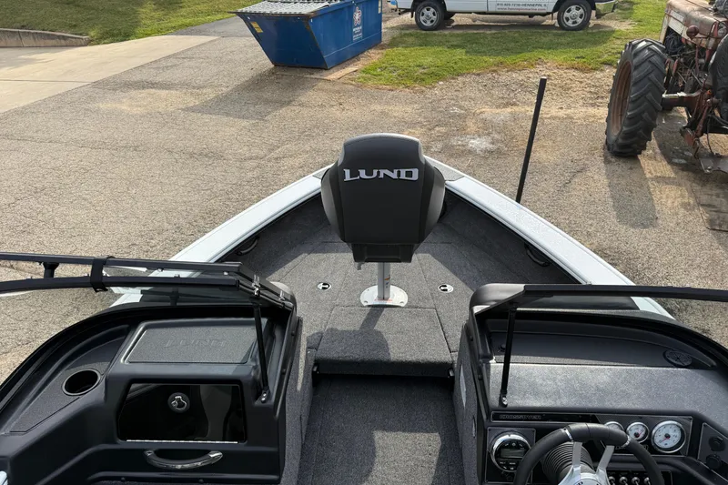 Slide: The Image of 2026 Lund 1875 Crossover XS boat interior with steering console and seating. - 16
