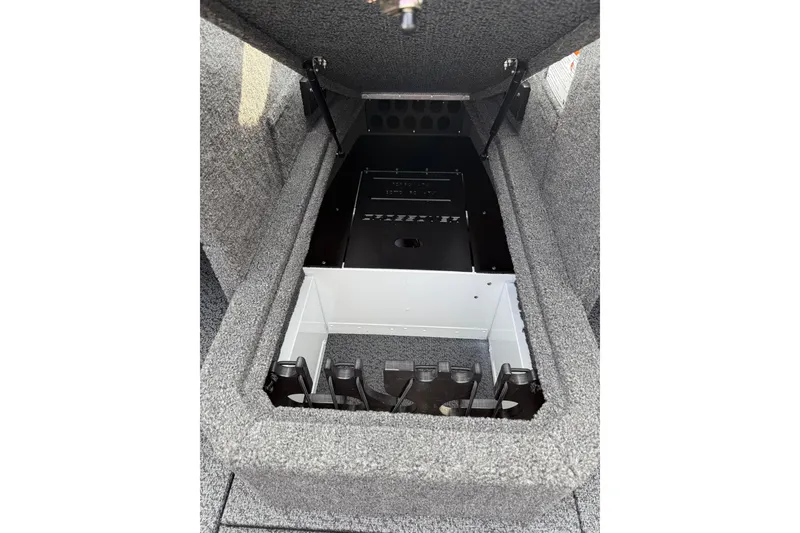 Slide: The Image of 2026 Lund 1875 Crossover XS boat storage compartment with open lid, showcasing interior design. - 18