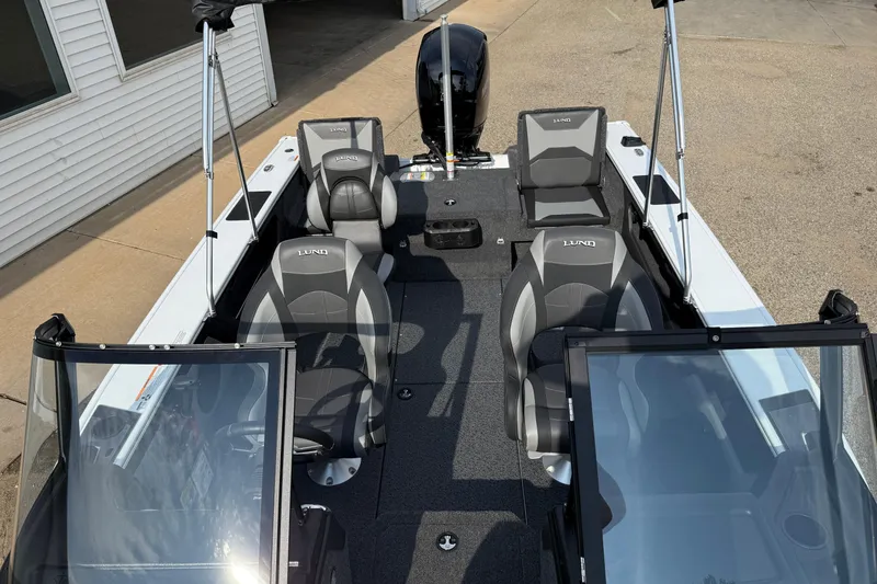Slide: The Image of 2026 Lund 1875 Crossover XS boat interior with seating and windshield. - 19