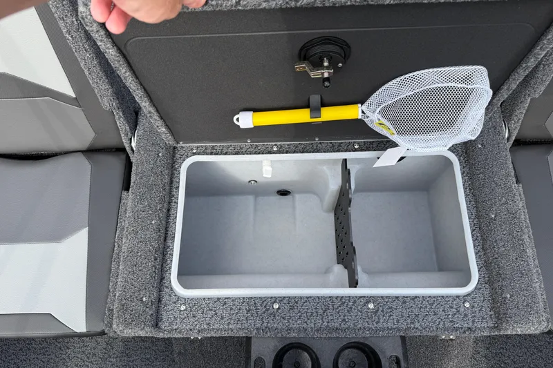 Slide: The Image of 2026 Lund 1875 Crossover XS boat storage compartment with net and secure latch. - 32