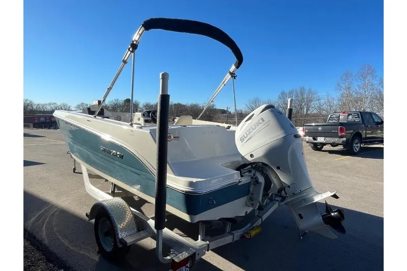 Slide: The Image of 2021 Stingray 172 SC boat with Suzuki outboard motor on trailer, parked outdoors. - 10