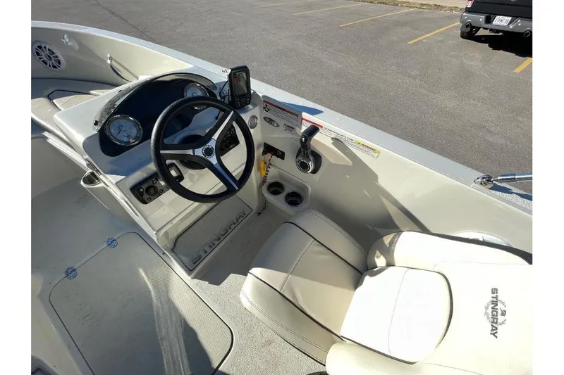 Slide: The Image of 2021 Stingray 172 SC boat interior with steering wheel and dashboard controls. - 6