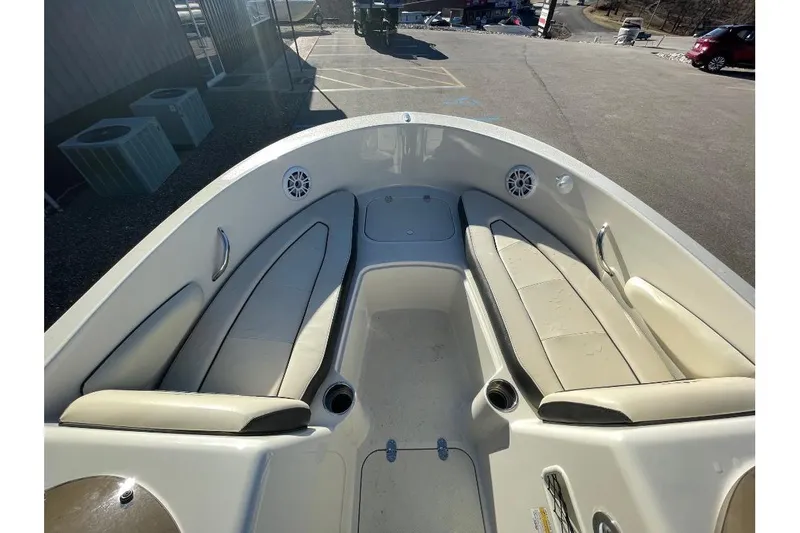 Slide: The Image of 2021 Stingray 172 SC boat interior with beige seating and cup holders. - 7