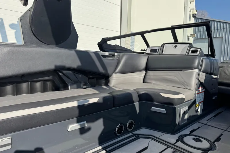 Slide: The Image of 2021 Supra SL 575 boat interior with sleek black and gray seating design. - 10