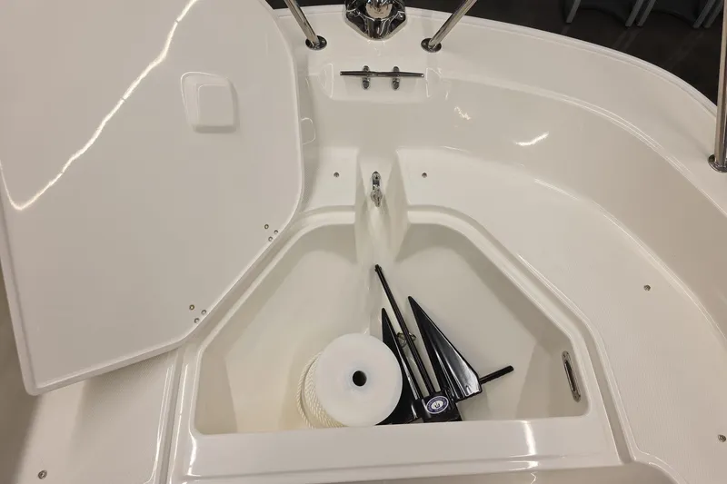 Slide: The Image of 2026 Boston Whaler 150 Montauk boat storage compartment with anchor and rope. - 16