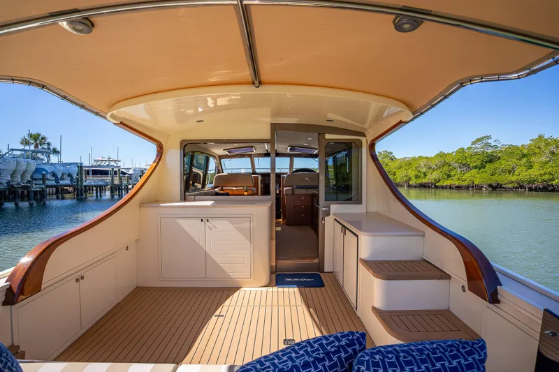 Slide: The Image of 2017 Palm Beach Motor Yachts PB45 interior with elegant wood finish and spacious seating area. - 10