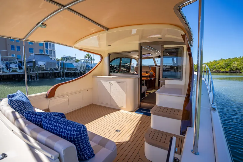 Slide: The Image of 2017 Palm Beach Motor Yachts PB45 interior with elegant seating and scenic marina view. - 11