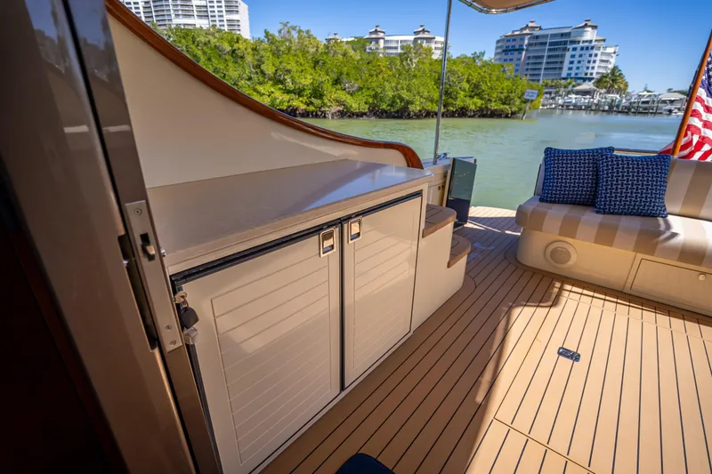 Slide: The Image of Luxurious 2017 Palm Beach Motor Yachts PB45 deck with seating and scenic waterfront view. - 14