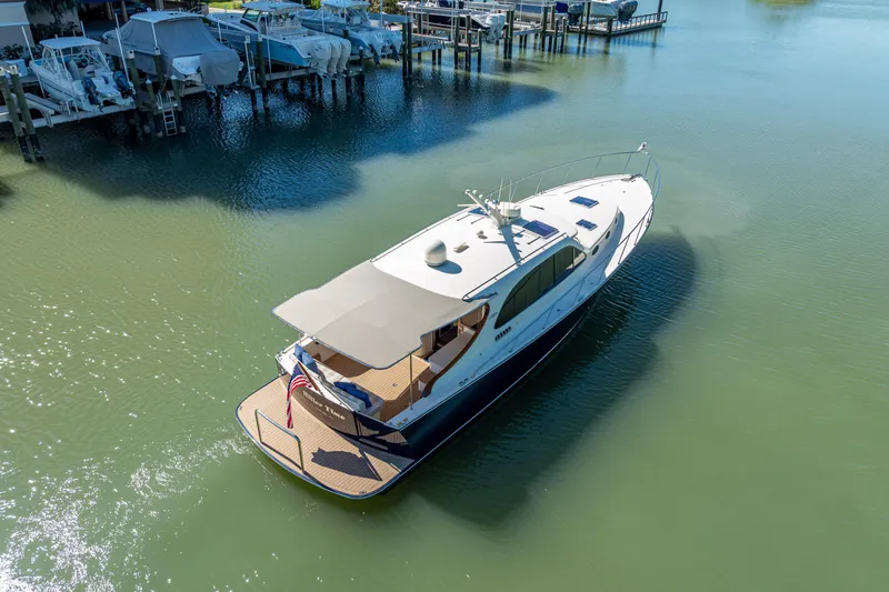 Slide: The Image of 2017 Palm Beach Motor Yachts PB45 cruising in a serene marina setting. - 17