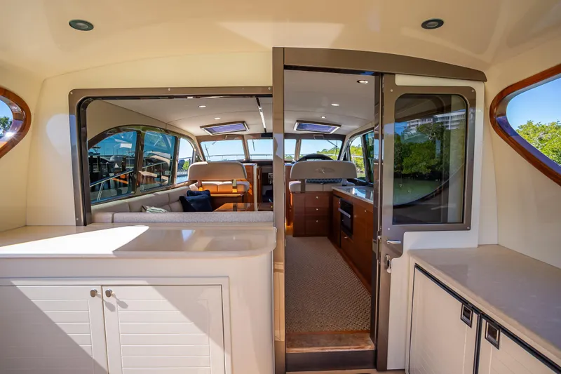 Slide: The Image of Luxurious interior of 2017 Palm Beach Motor Yachts PB45, featuring elegant seating and cabinetry. - 21