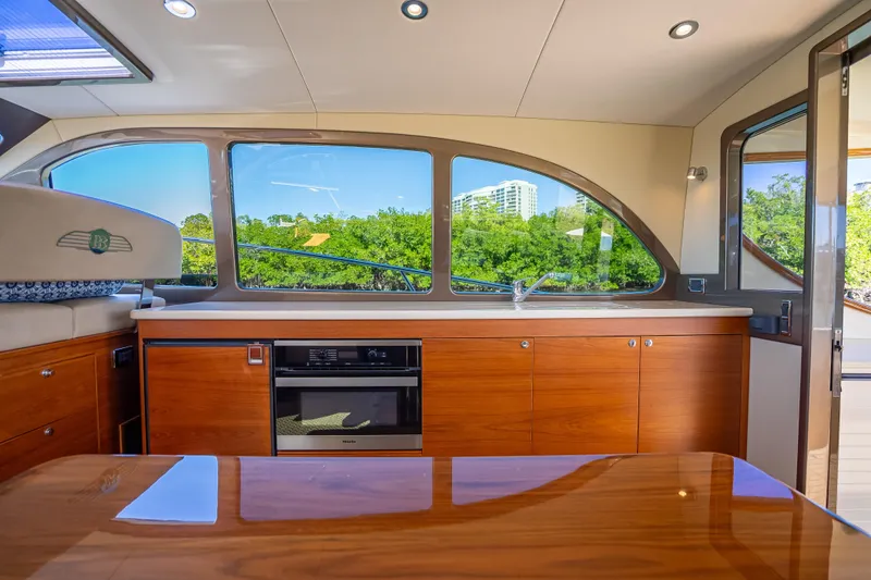 Slide: The Image of Luxurious interior of 2017 Palm Beach Motor Yachts PB45 with sleek wood cabinetry and large windows. - 26