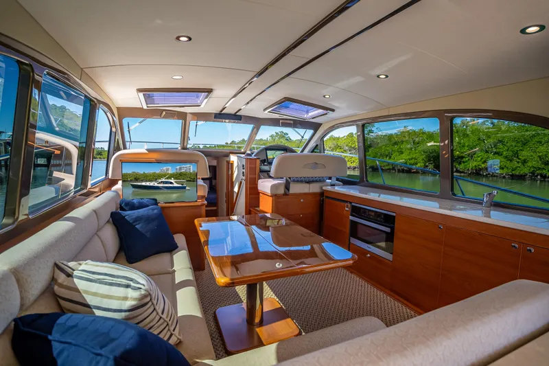 Slide: The Image of Luxurious interior of 2017 Palm Beach Motor Yachts PB45 with elegant seating and panoramic windows. - 27