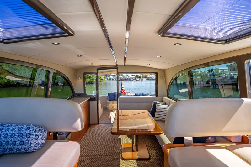 Slide: The Image of Luxurious interior of 2017 Palm Beach Motor Yachts PB45 with panoramic windows and elegant seating. - 3