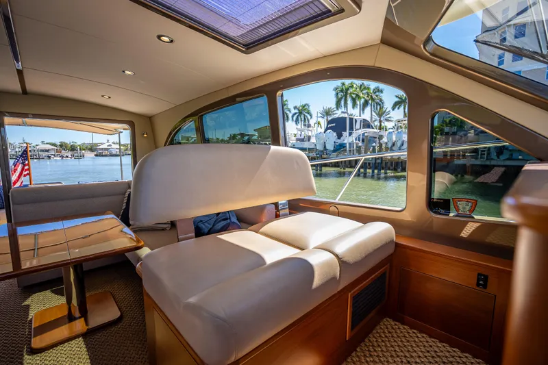 Slide: The Image of Interior of 2017 Palm Beach Motor Yachts PB45, featuring elegant seating and waterfront views. - 34