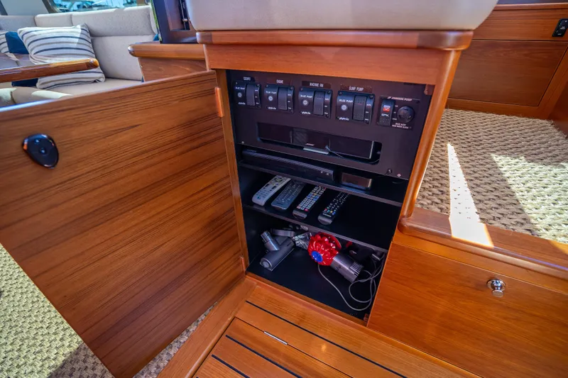 Slide: The Image of 2017 Palm Beach Motor Yachts PB45 interior cabinet with control panel and storage. - 35