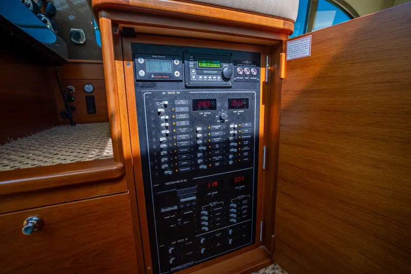 Slide: The Image of Electrical control panel inside 2017 Palm Beach Motor Yachts PB45, featuring various switches and displays. - 36