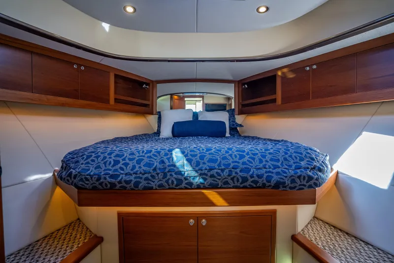 Slide: The Image of Luxurious cabin interior of 2017 Palm Beach Motor Yachts PB45 with elegant bedding and wood finishes. - 38