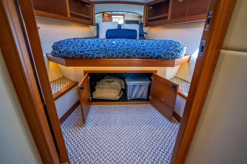 Slide: The Image of Luxurious 2017 Palm Beach Motor Yachts PB45 cabin interior with storage and cozy bedding. - 39